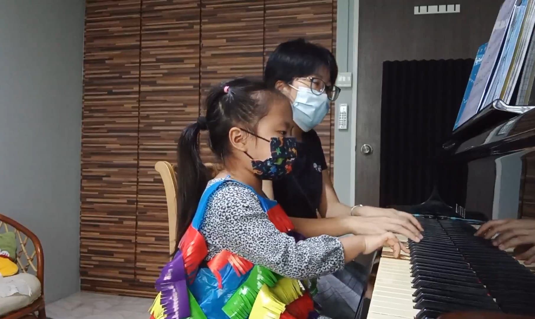 Young piano students in a group class learning together